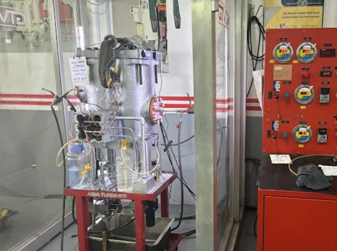 Close-up of a turbine generator test rig branded Asia Turbines, wired to a gauge control panel